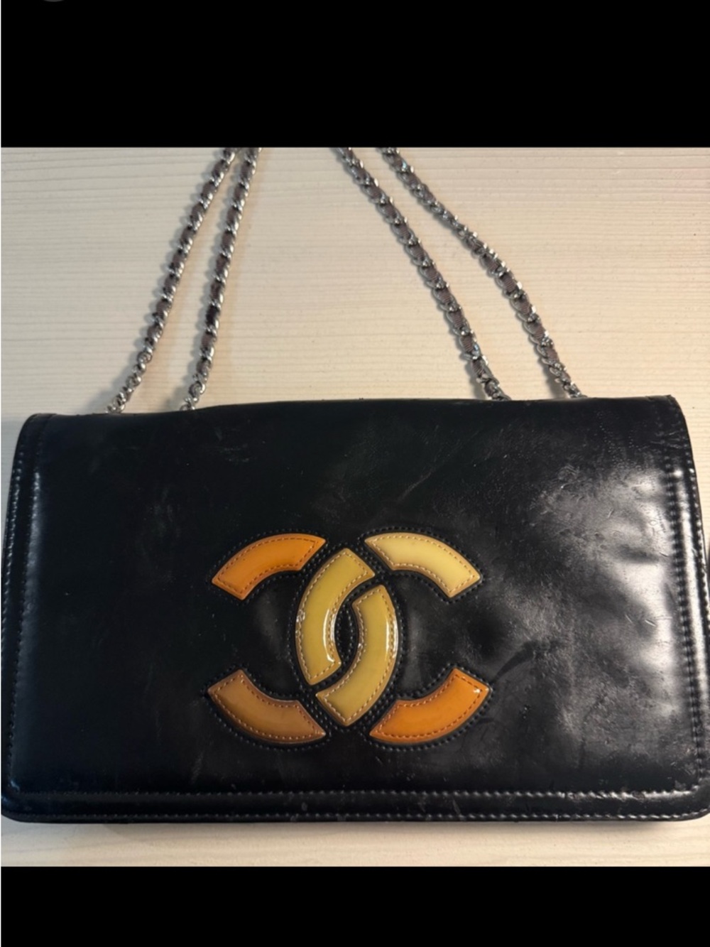 CHANEL Black Leather Shoulder Bag with Yellow and Orange CC Logo